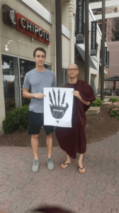 monk holding posters